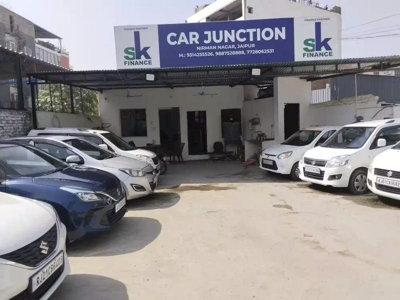 Car Junction showroom front with its blue sign and cars parked outside